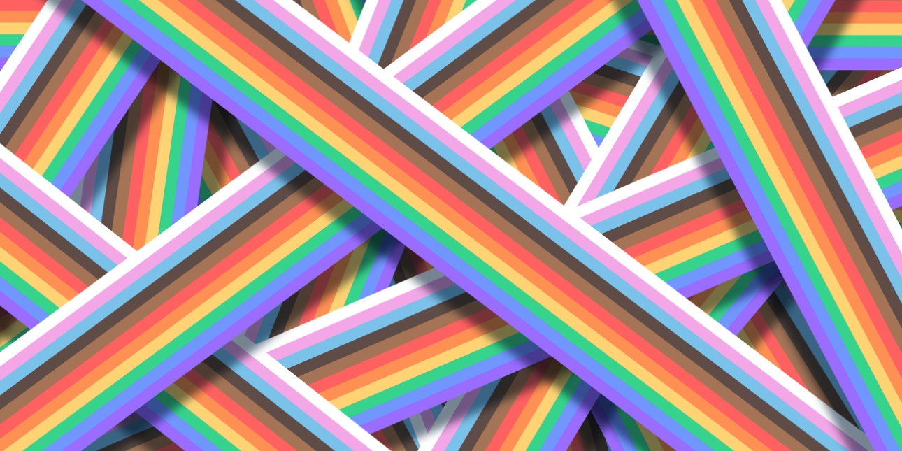 An assortment of overlapping stripes formed of the LGBT+ pride flag colours of white, pink, light blue, black, brown, red, orange, yellow, green, blue and violet