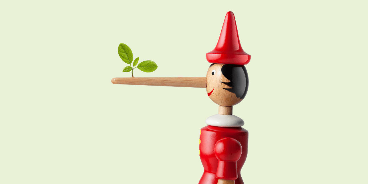 A side profile of a wooden Pinocchio figure with a long nose from which a three-leafed shrub has grown. Pinocchio has a pointed red hat and tunic. The background is pale green