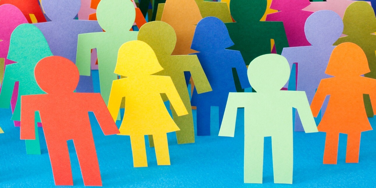 A selection of paper figures in a spectrum of colours on a blue background