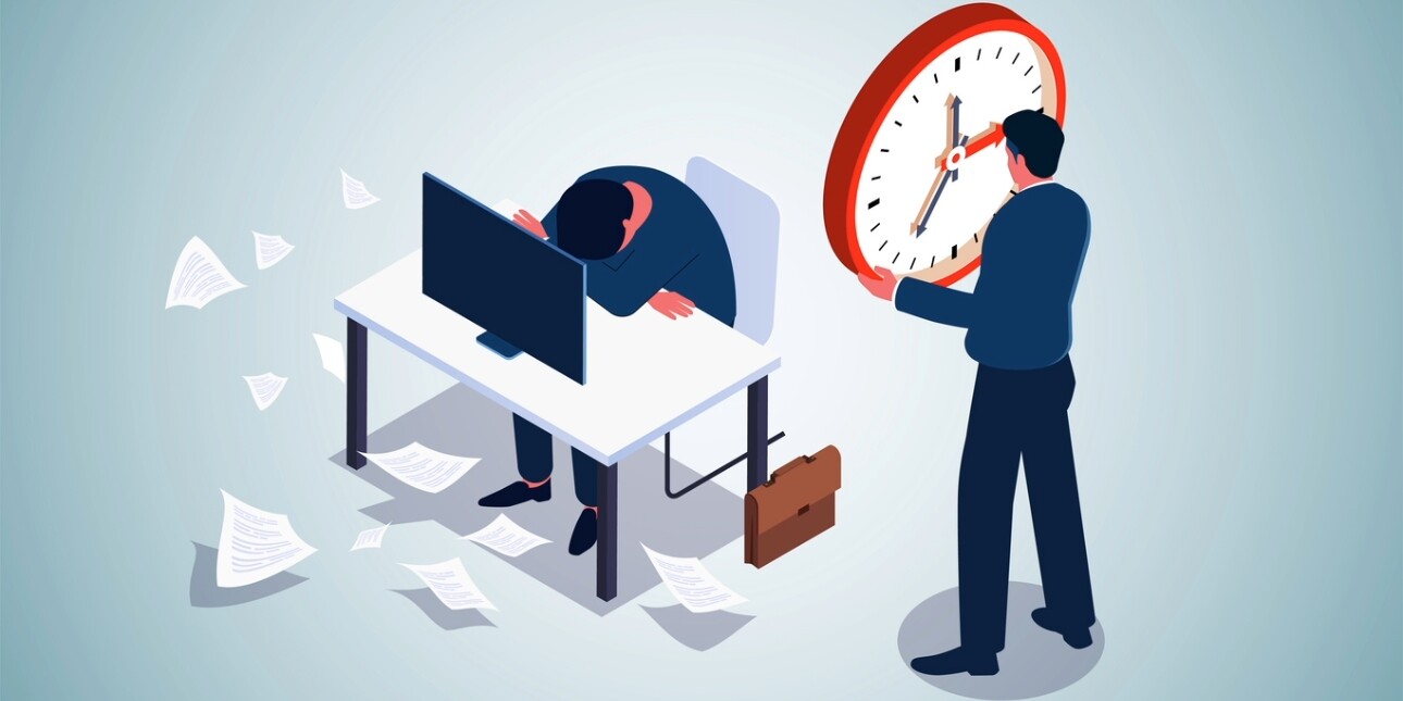 An illustration of a man with his head on a desk surrounded by papers while another man fits a clock to the wall