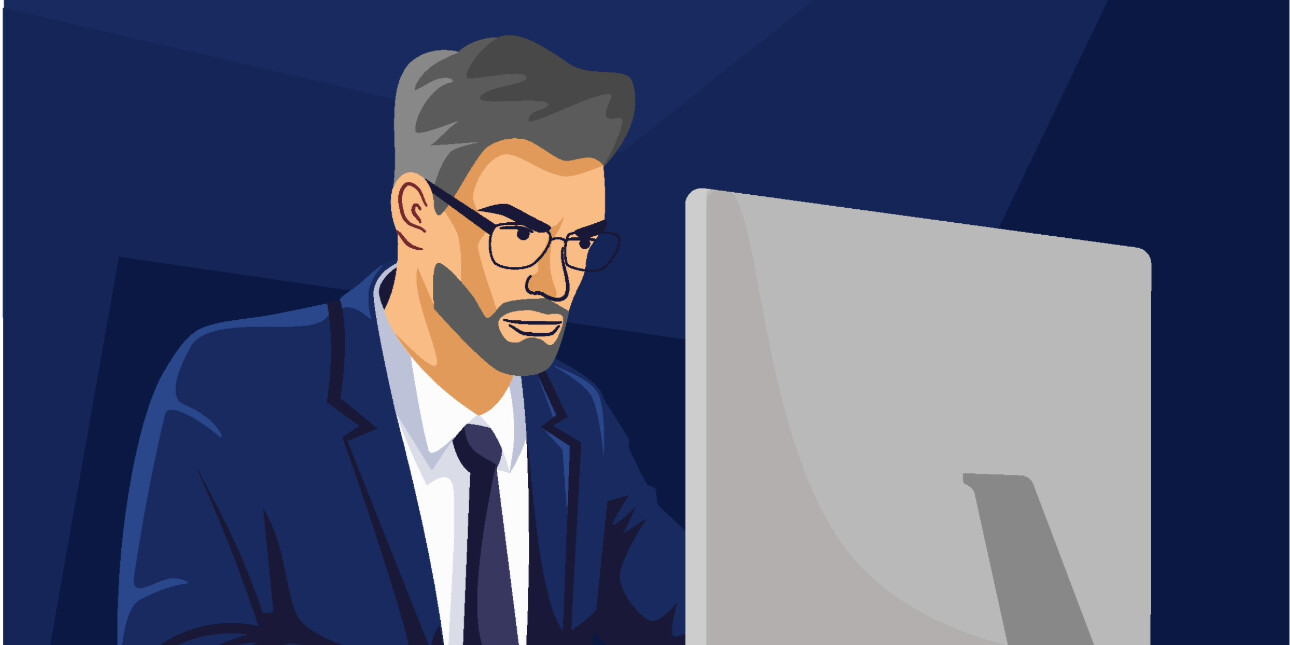 An illustration of a white businessman with grey hair and beard and blue suit, sat in front of a computer. The background is navy.