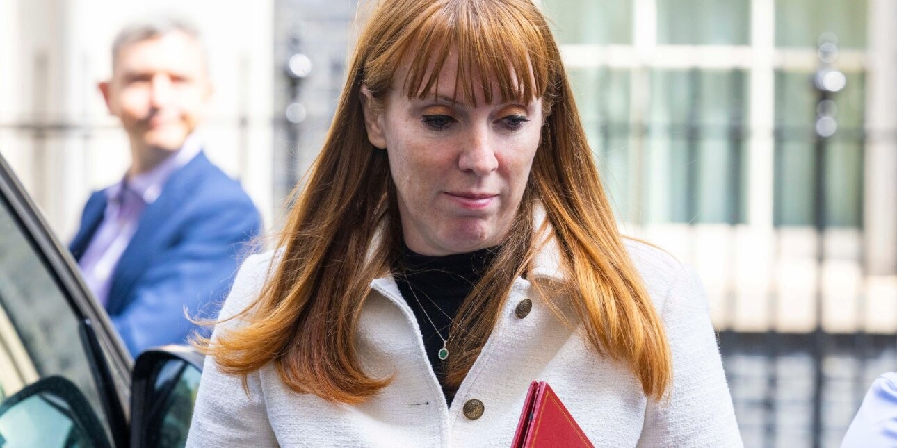 Angela Rayner with her eyes looking downwards while carrying a red ministerial folder.