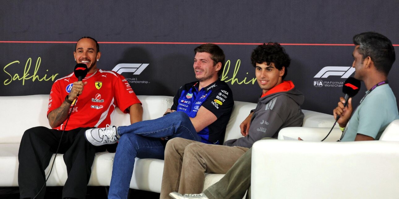Drivers Lewis Hamilton, Max Verstappen and Gabriel Bortoleto and F1 presenter Lawrence Barretto sat on a beige couch in front of a grey screen.