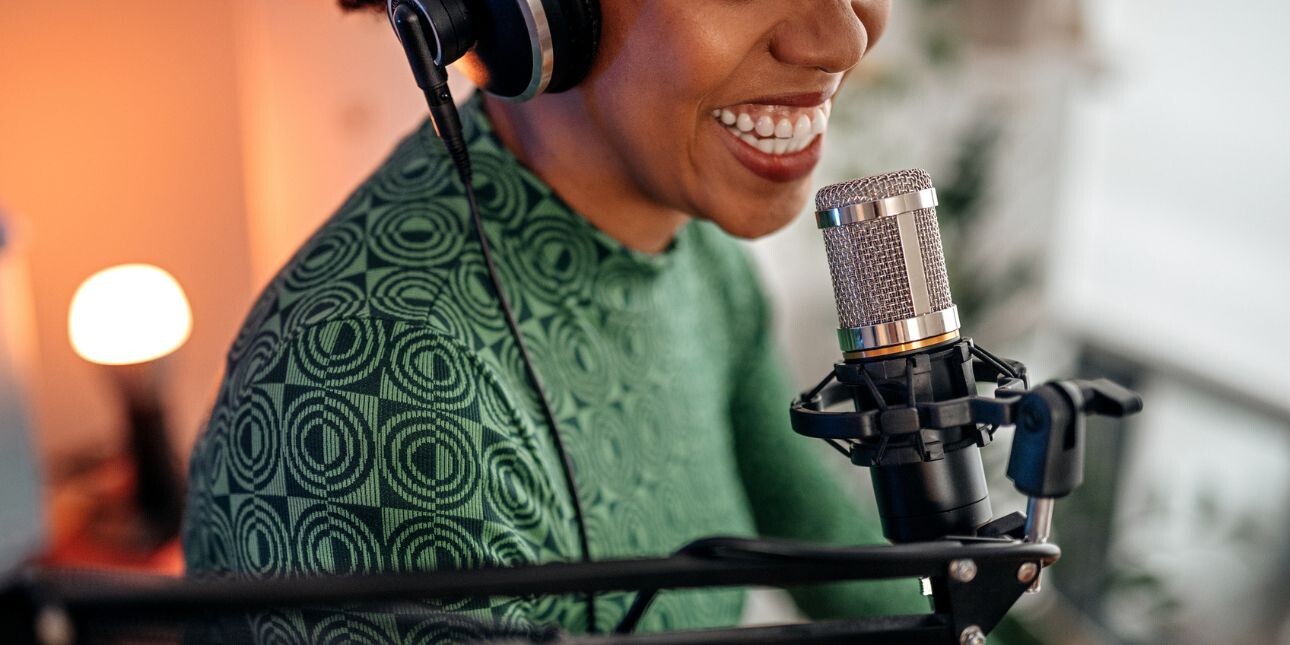 smiling woman recording podcast
