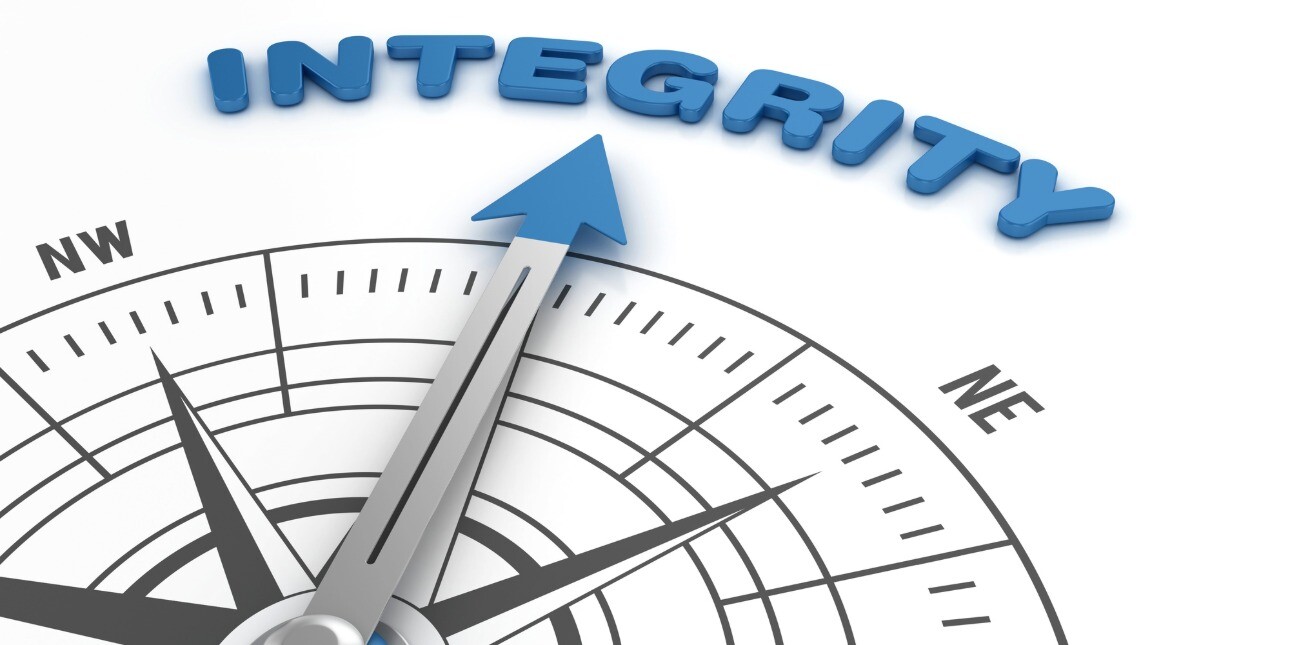 A digital image of a compass needle pointing to the word Integrity written in blue.