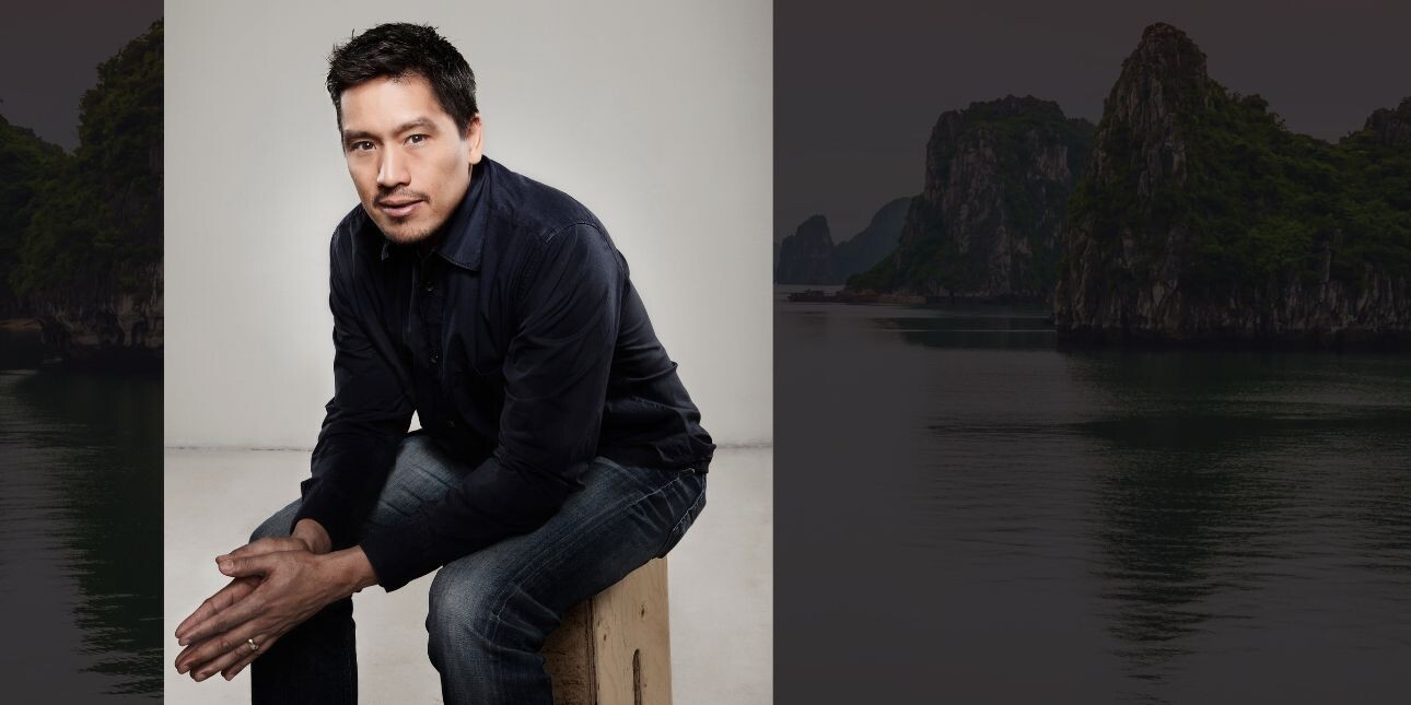 A portrait of Bruce Poon Tip sat on a stool, overlaid on an image of islands in an expanse of water.