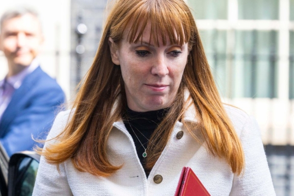 Angela Rayner with her eyes looking downwards while carrying a red ministerial folder.