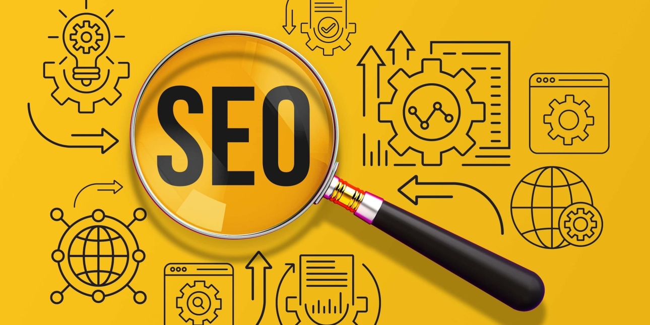 A magnifying glass is placed on a bright yellow background. The letters SEO are within the lens. Alongside are icons of cogs, computer files, arrows and a lightbulb
