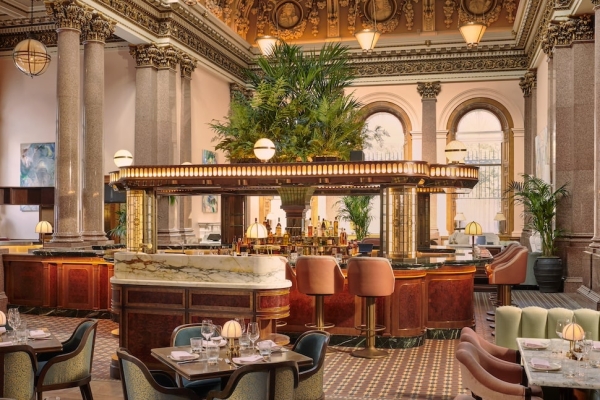 The opulent canopied bar and dining room at Gleneagles townhouse with marble pillars, friezes and a large palm. Decoration and furnishings are mostly pistachio green and pastel pink