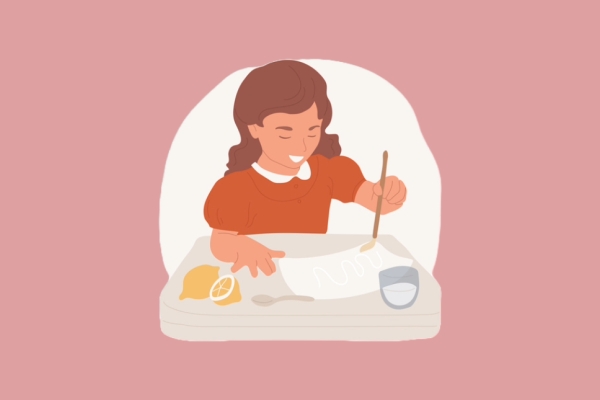 An illustration of a brown-haired young girl in a red dress who is using lemon juice to write an 'invisible' message on a sheet of white paper. The background is terracotta.