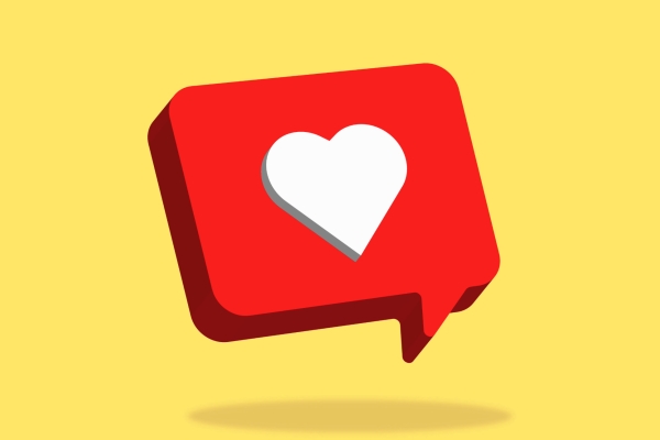 A computer generated image of a white heart shape on a three dimensional red speech bubble on a yellow background