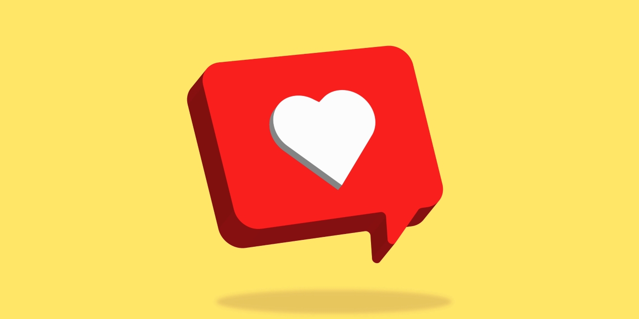 A computer generated image of a white heart shape on a three dimensional red speech bubble on a yellow background