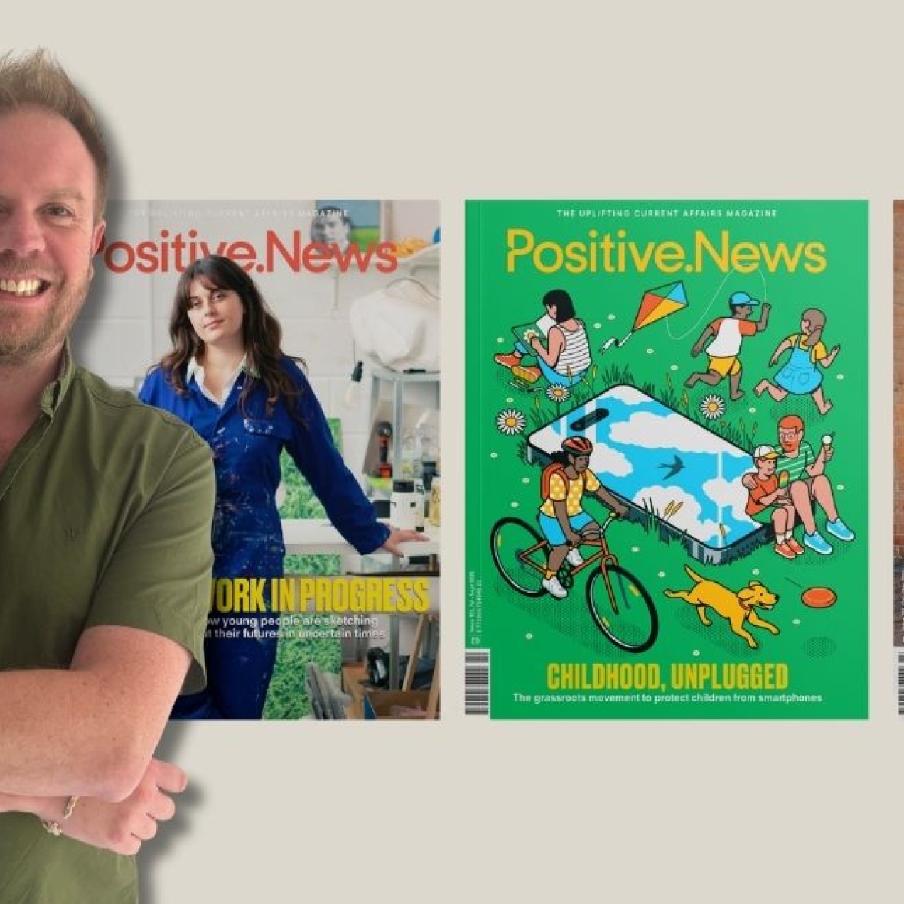 A cut out of a smiling Tom Pattinson placed in front of four covers of Positive News magazine. Tom is a white man with short light brown hair who is stood with his arms crossed and wearing a green shirt.