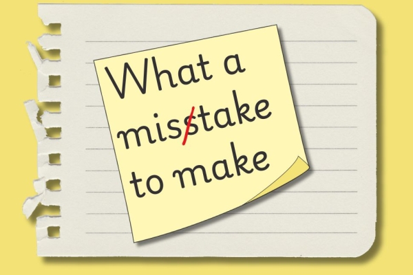 An illustration of a yellow sticky note on a torn sheet of lined paper. Written on the sticky note are the words what a misstake to make. But the word mistake is deliberately spelt with two letters s. A red line is struck through the superfluous s.