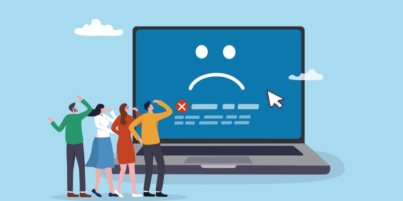 An illustration of four people looking bemused while stood in front of a giant laptop. The screen shows a sad face and a white x inside a red circle.