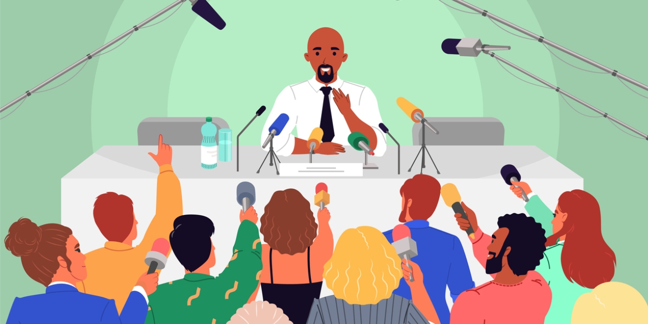 Illustration of a man with brown skin, bald head and black goatee beard, who wears a white shirt and black tie, giving a press conference. In the foreground are ten journalists of different genders and ethnicities, wearing bright clothing and holding