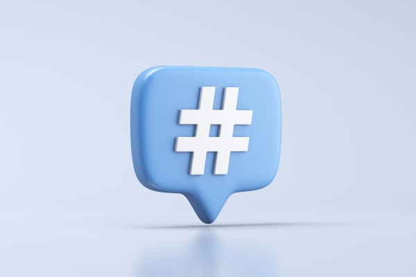 A computer generated image of a light blue, three-dimensional speech bubble featuring a white hashtag symbol in the centre