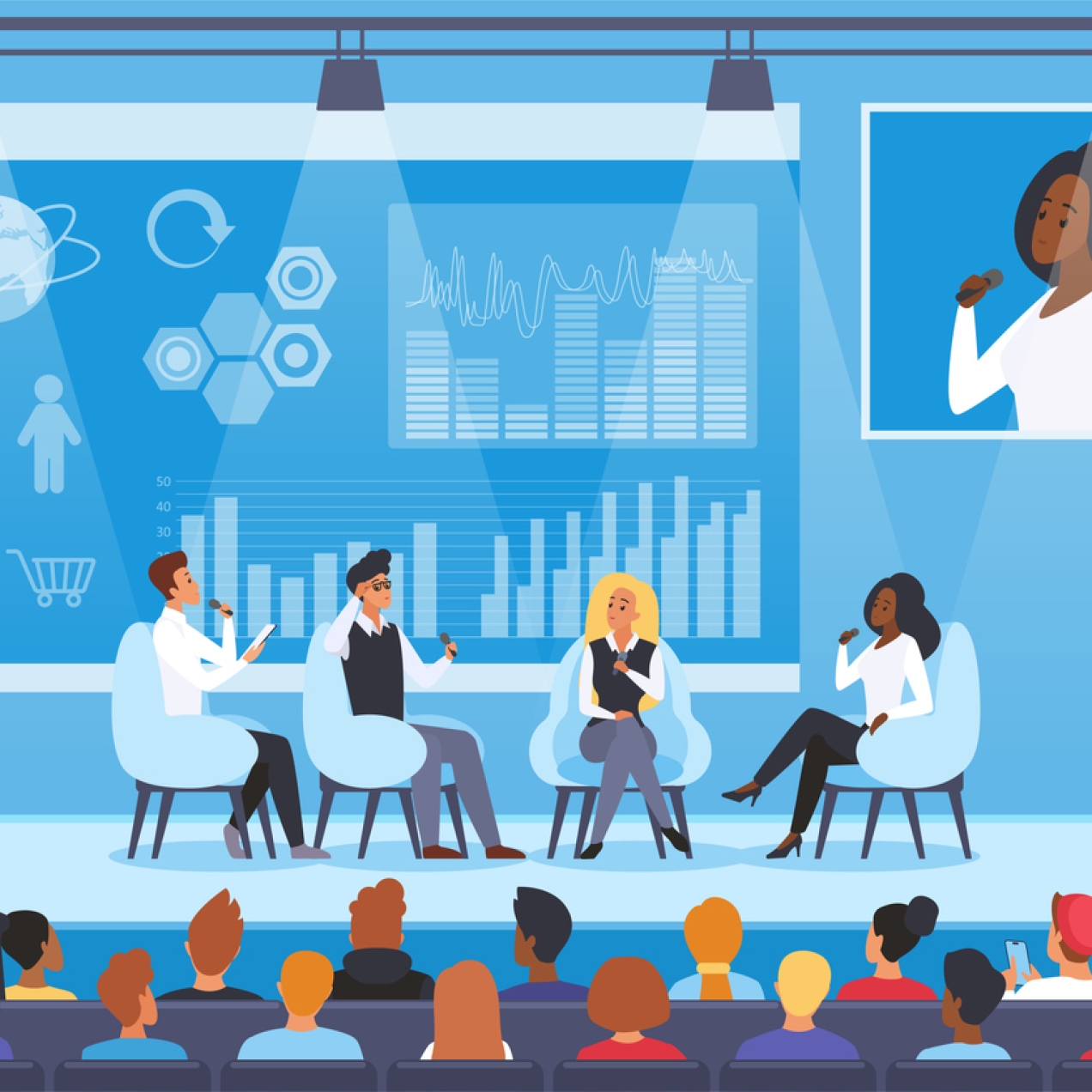 Four people of different ethnicities and gender sat on chairs on a conference stage in front of two rows of audience. Behind them is a screen with various graphics and an larger image of the current speaker, a Black woman in a white shirt, holding a