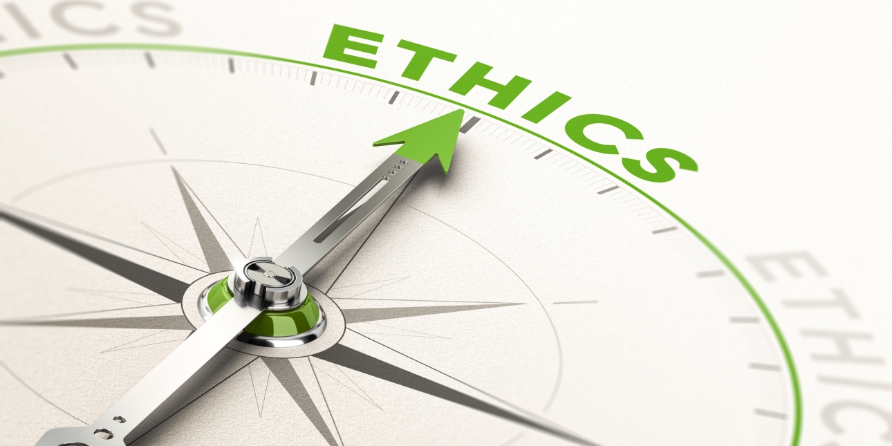 A silver compass needle pointing at the word ethics. The tip of the needle and the word are in green.