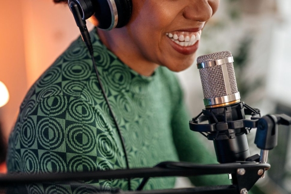 smiling woman recording podcast