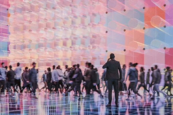 A digitised image of a crowd of people walking past a futuristic looking pink, coloured cube structure.