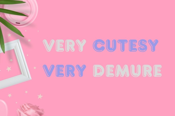 A bird's eye view of green leaves, pink coffee cup lid, pinks stars, pink heart, white picture frame and the words very cutesy very demure in a rounded typeface