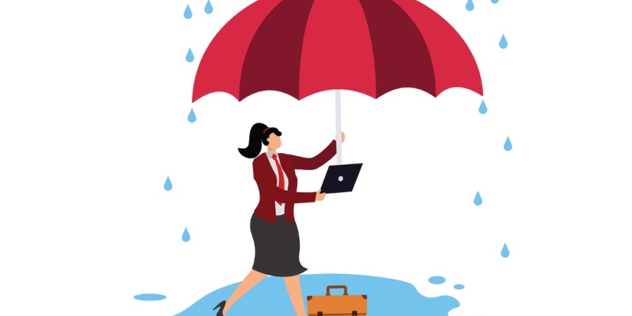 Illustration of a light skinned woman with a black ponytail and wearing a business suit. She shelters under a large umbrella that she holds in her left hand. In her right hand she holds a laptop. while also holding a laptop. She and her briefcase are
