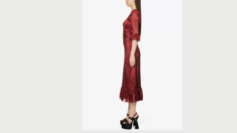 A headless model wears a mid-length red dress an clumpy black shoes