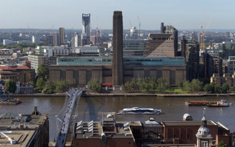 A view across the Thames of the red brick chimney and buildings of the Tate Modern.