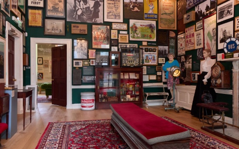 A room with walls covered in various sized frames