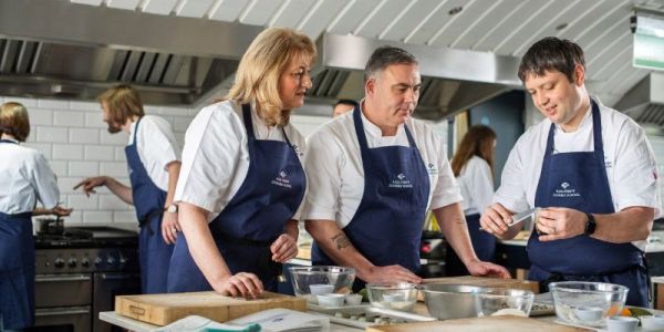 group cooking at rick stein's cookery school